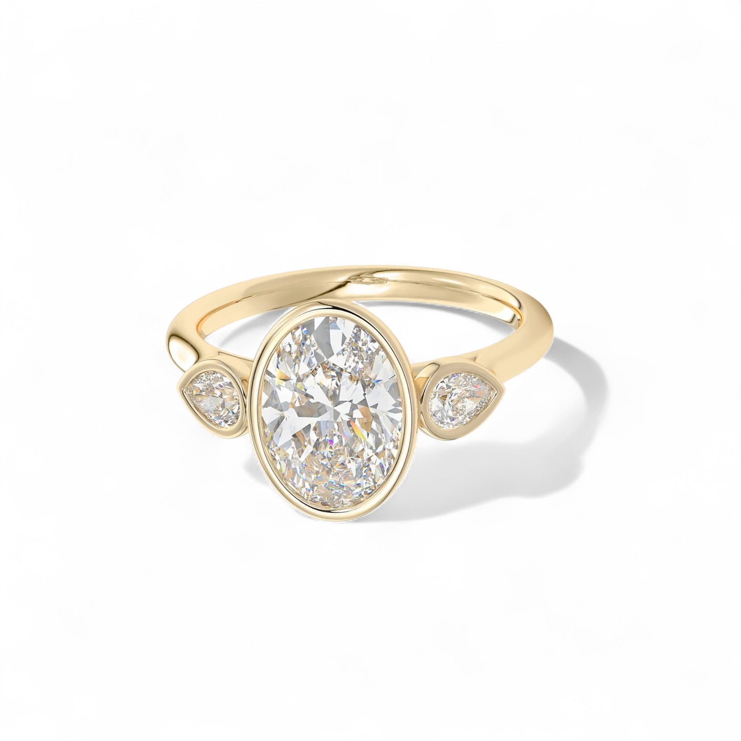 The Celine Oval Bezel Three-Stone Diamond Ring