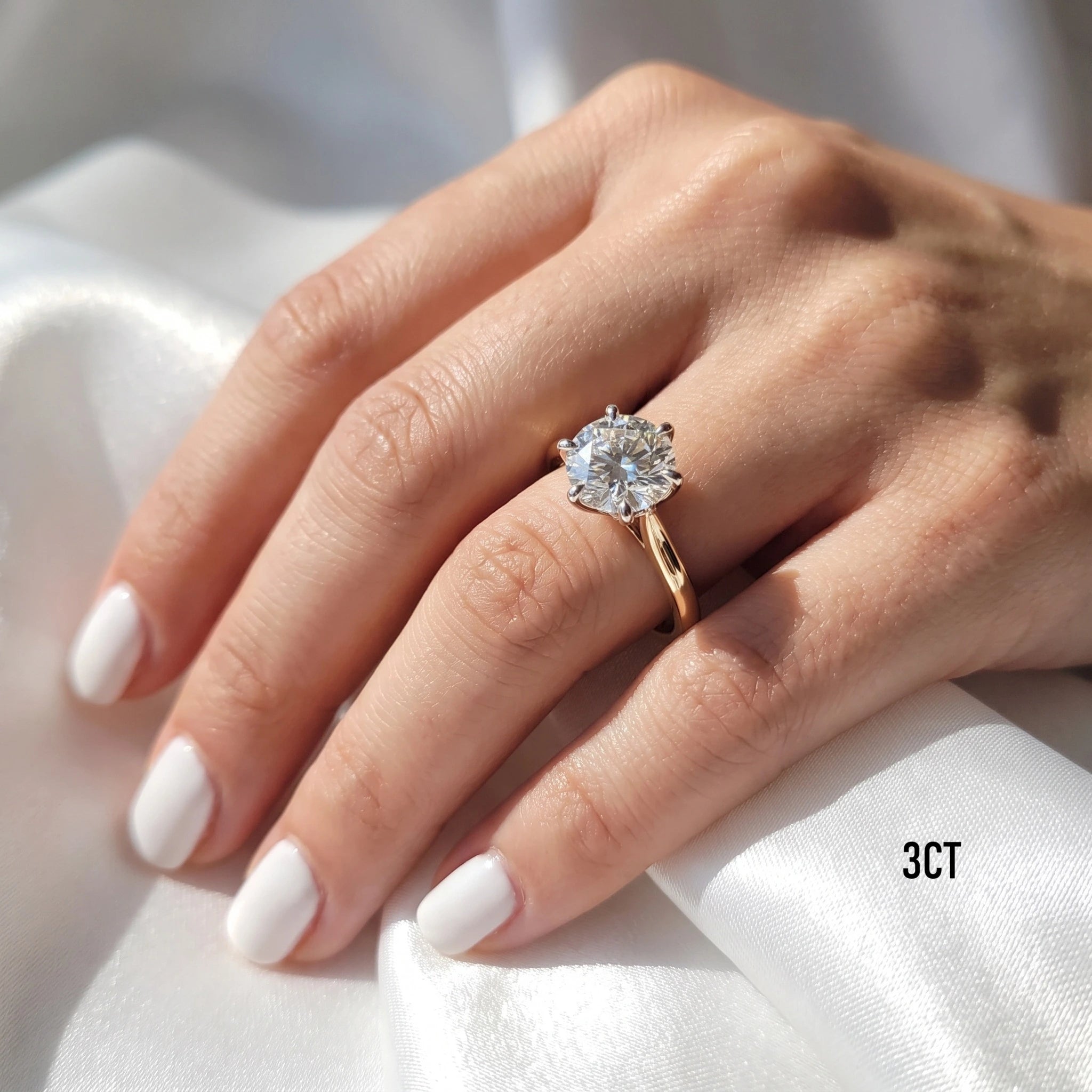 Close-up of a hand wearing the Shenae tulip setting engagement ring