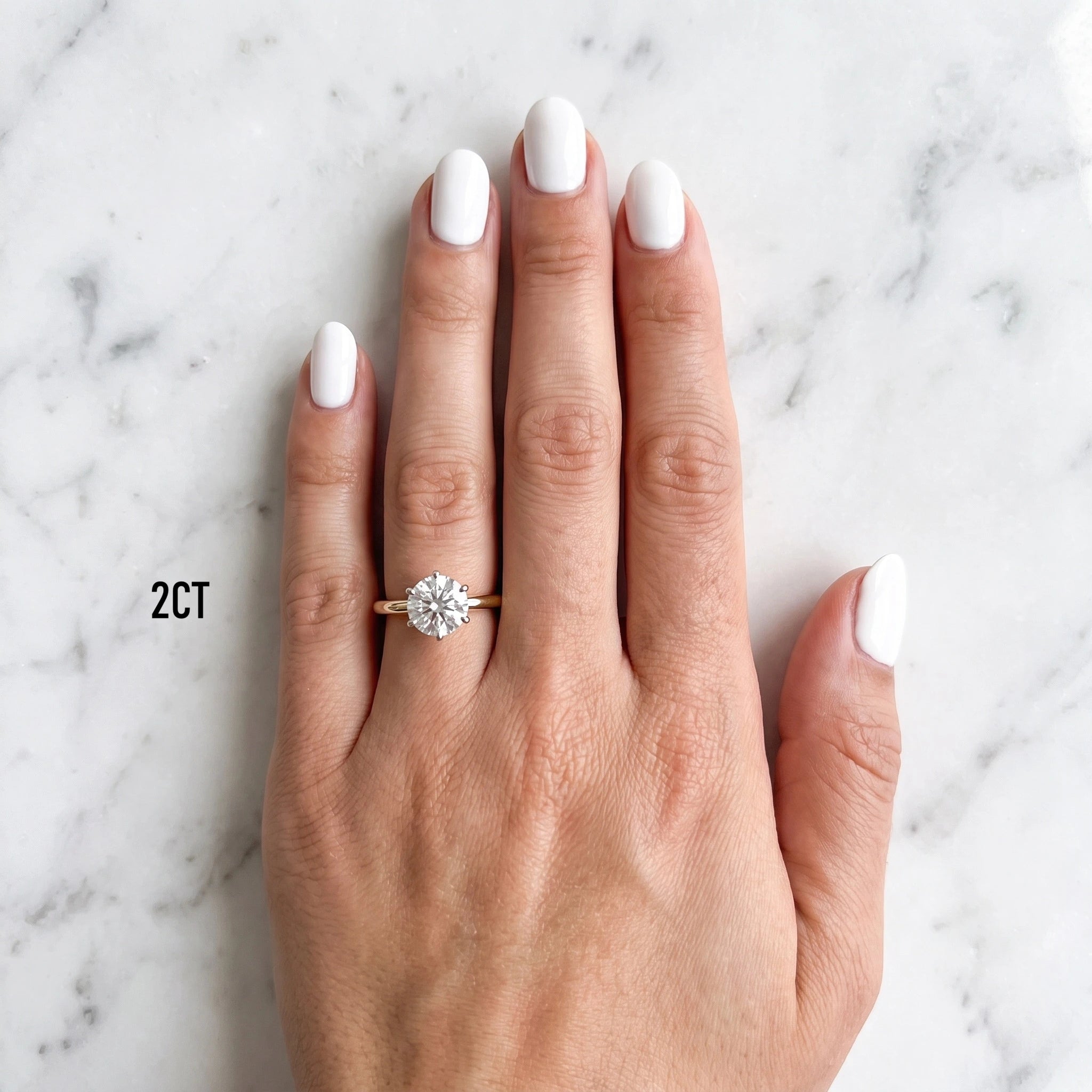 Hand wearing the Shenae six-claw tulip solitaire engagement ring