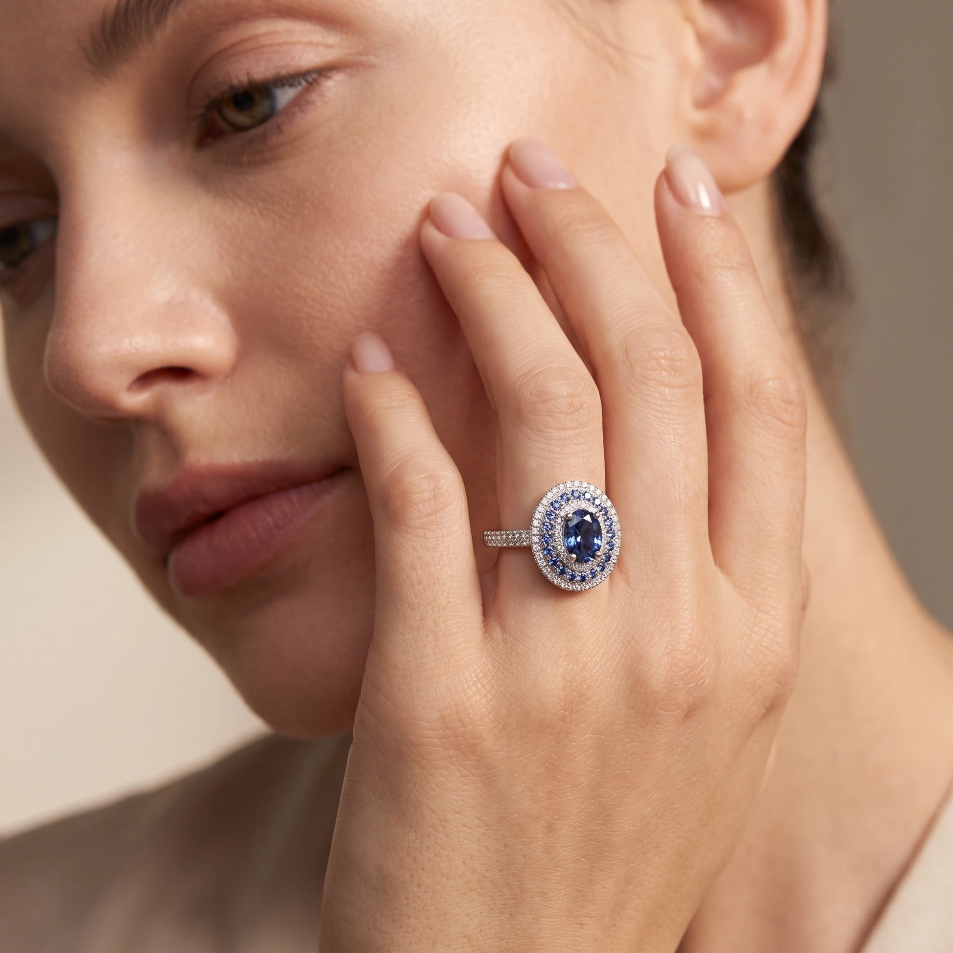 Blue moissanite halo ring worn, high-fashion campaign style