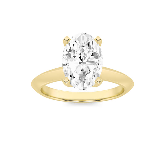 Gold ring with a large clear gemstone on a white background