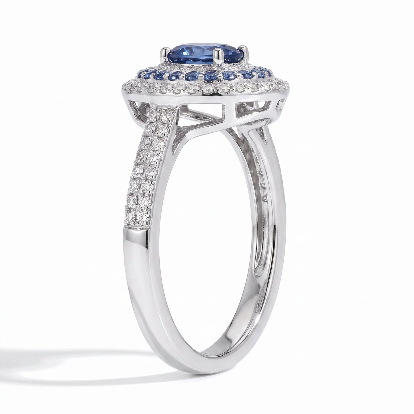 Oval blue moissanite double halo ring angled on white background