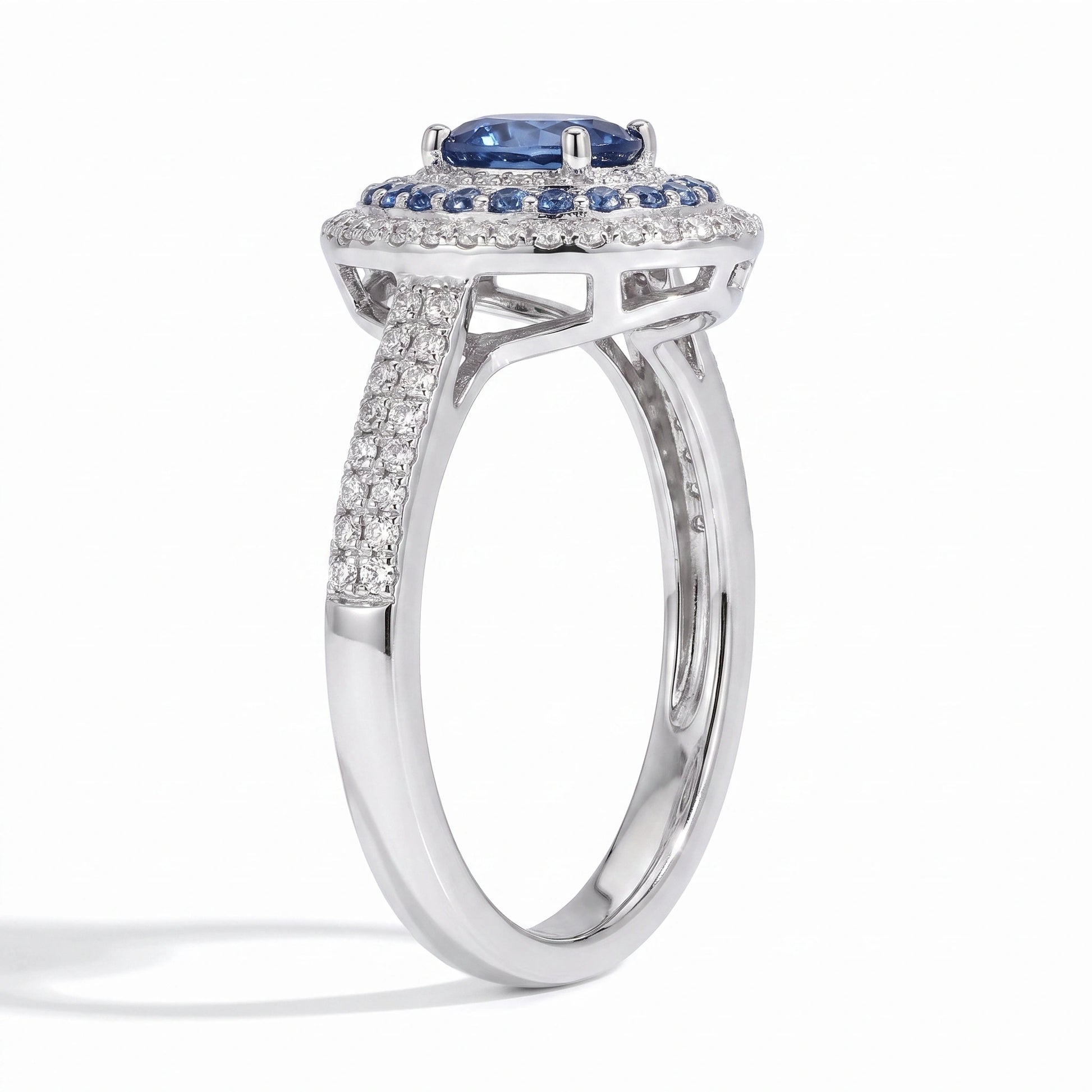 Oval blue moissanite double halo ring angled on white background