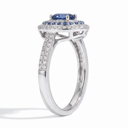 Oval blue moissanite double halo ring angled on white background