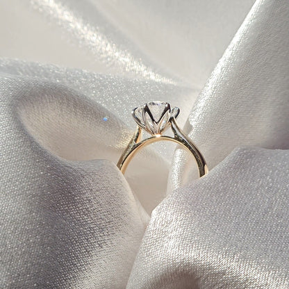 Tulip round solitaire diamond ring, side profile showing the raised basket